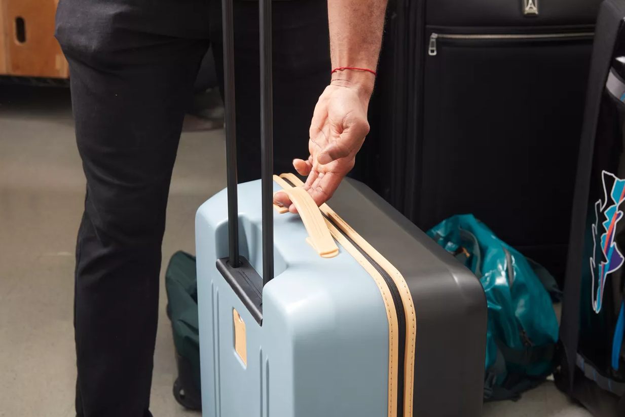 Travelpro Platinum Elite handle extended next to a jet bridge