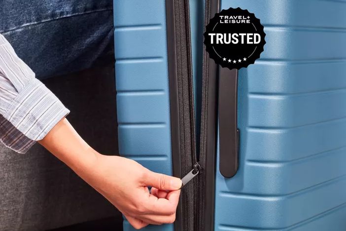 zipper pull close-up on a backpack front pocket, showing wear
