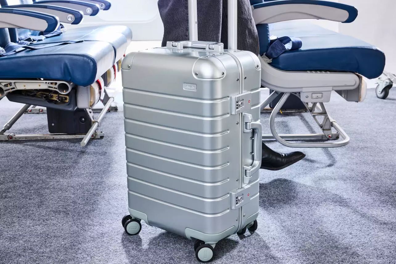 Maxlite 5 carry-on standing next to a boarding gate sizer